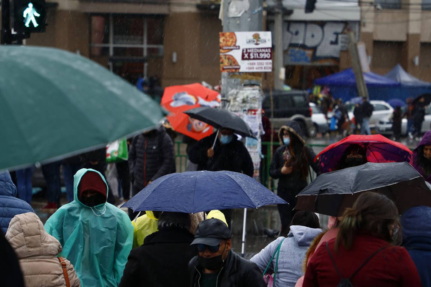 Gente por la calle bajo la lluvia.