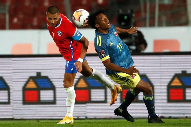 Juan Guillermo Cuadrado, en la imagen enfrentando a Alexis Sánchez en Eliminatorias, no irá a Estados Unidos. Foto: Agencia Aton.