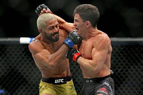Feb 29, 2020; Norfolk, Virginia, USA; Joseph Benavidez (red gloves) fights Deiveson Figueiredo (blue gloves) during UFC Fight Night at Chartway Arena. Mandatory Credit: Peter Casey-USA TODAY Sports
