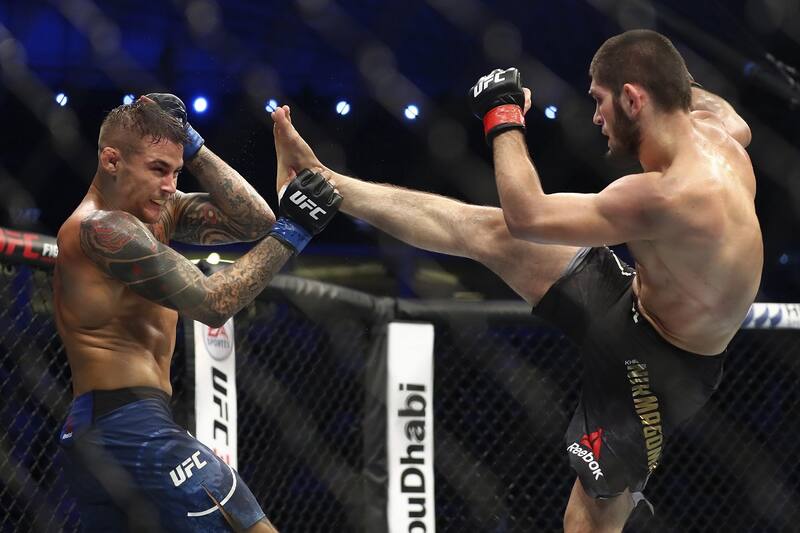 Russian UFC fighter Khabib Nurmagomedov, right, kicks UFC fighter Dustin Poirier, of Lafayette, La., during Lightweight title mixed martial arts bout at UFC 242, in Yas Mall in Abu Dhabi, United Arab Emirates, Saturday , Sept.7 2019. (AP Photo/ Mahmoud Khaled) ORG XMIT: ASC133