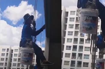 Mujer corta las cuerdas de seguridad de dos trabajadores y los deja colgando a 60 metros de altura