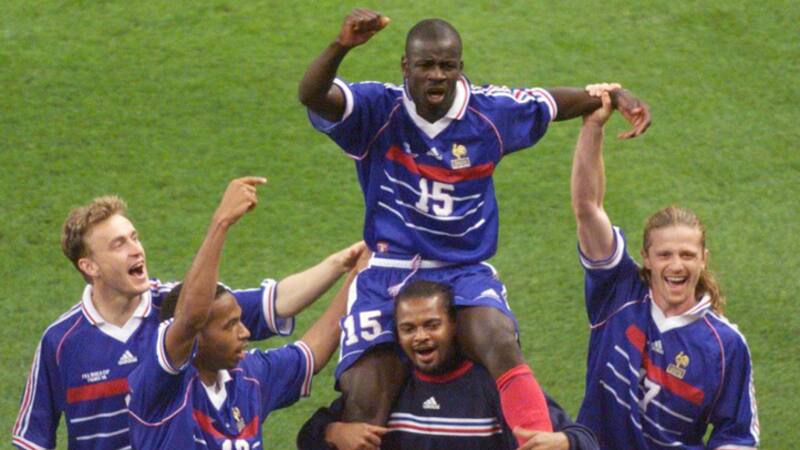(FILES) In this file photo taken on July 8, 1998 French defender Lilian Thuram , who scored the two goals for his team, is carried on the shoulders of goalkeeper Bernard Lama as they celebrate with (from L) Stephane Guivarc'h, Thierry Henry, and Emmanuel Petit France defeated Croatia 2-1 in their World Cup semi-final match, at the Stade de France in Saint-Denis, north of Paris. France team will play against Belgium in Saint Petersburg on July 10, 2018, its sixth World Cup semi-final. On July 8, 1998 France played against Croatia in Saint-Denis, and won 2-1. / AFP PHOTO / Thomas COEX