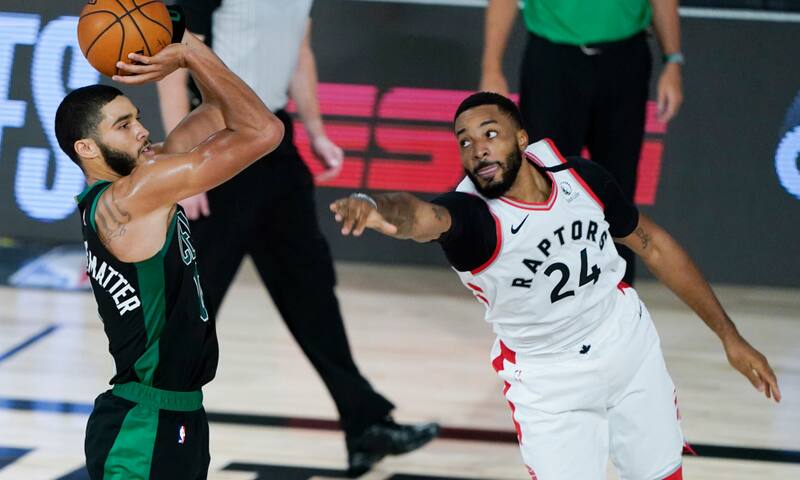 Boston Celtics' Jayson Tatum shoots as Toronto Raptors' Norman Powell (24) defends during the second half of an NBA basketball conference semifinal playoff game Sunday, Aug. 30, 2020, in Lake Buena Vista, Fla. (AP Photo/Ashley Landis) ORG XMIT: TNMH147