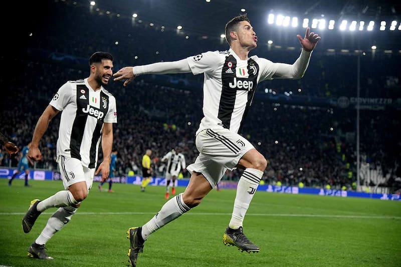 Soccer Football - Champions League - Round of 16 Second Leg - Juventus v Atletico Madrid - Allianz Stadium, Turin, Italy - March 12, 2019 Juventus' Cristiano Ronaldo celebrates scoring their third goal to complete his hat-trick with Emre Can REUTERS/Alberto Lingria