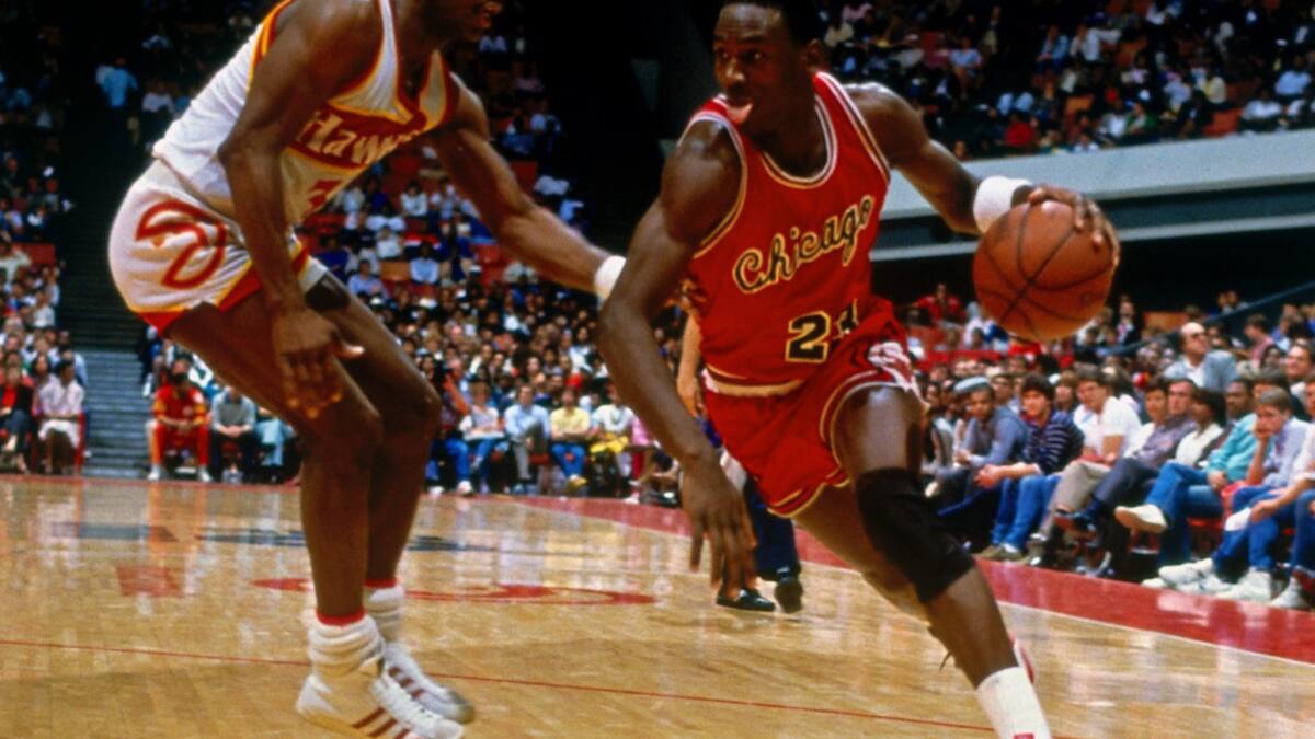 ATLANTA - 1984: Michael Jordan #23 of the Chicago Bulls dribbles against the Atlanta Hawks during his rookie season of 1984 at the Omni in Atlanta, Georgia. NOTE TO USER: User expressly acknowledges and agrees that, by downloading and or using this photograph, User is consenting to the terms and conditions of the Getty Images License Agreement. Mandatory Copyright Notice: Copyright 1984 NBAE (Photo by Scott Cunningham/NBAE via Getty Images)