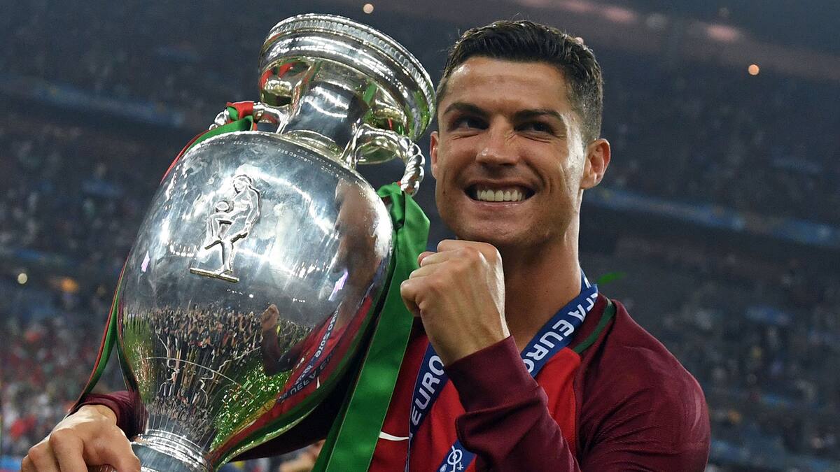 Portugal's forward Cristiano Ronaldo smiles while posing with the trophy after Portugal won the Euro 2016 final football match between Portugal and France at the Stade de France in Saint-Denis, north of Paris, on July 10, 2016. / AFP / FRANCISCO LEONG (Photo credit should read FRANCISCO LEONG/AFP/Getty Images)