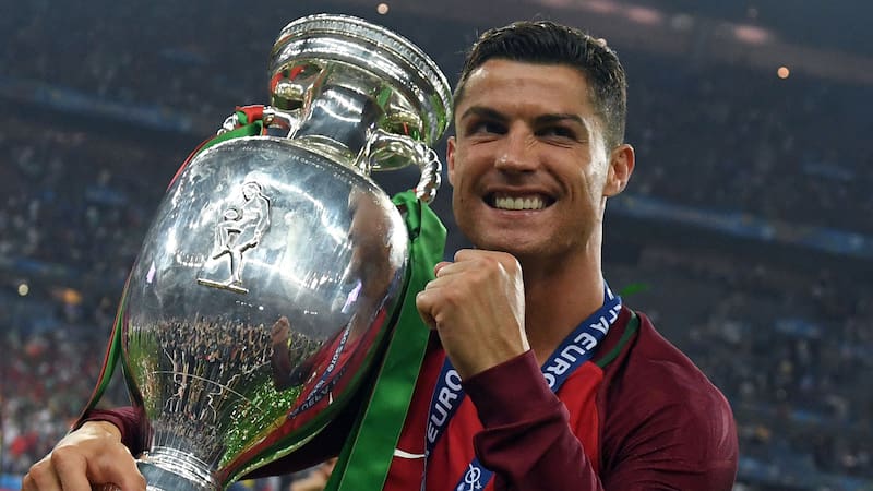 Portugal's forward Cristiano Ronaldo smiles while posing with the trophy after Portugal won the Euro 2016 final football match between Portugal and France at the Stade de France in Saint-Denis, north of Paris, on July 10, 2016. / AFP / FRANCISCO LEONG        (Photo credit should read FRANCISCO LEONG/AFP/Getty Images)