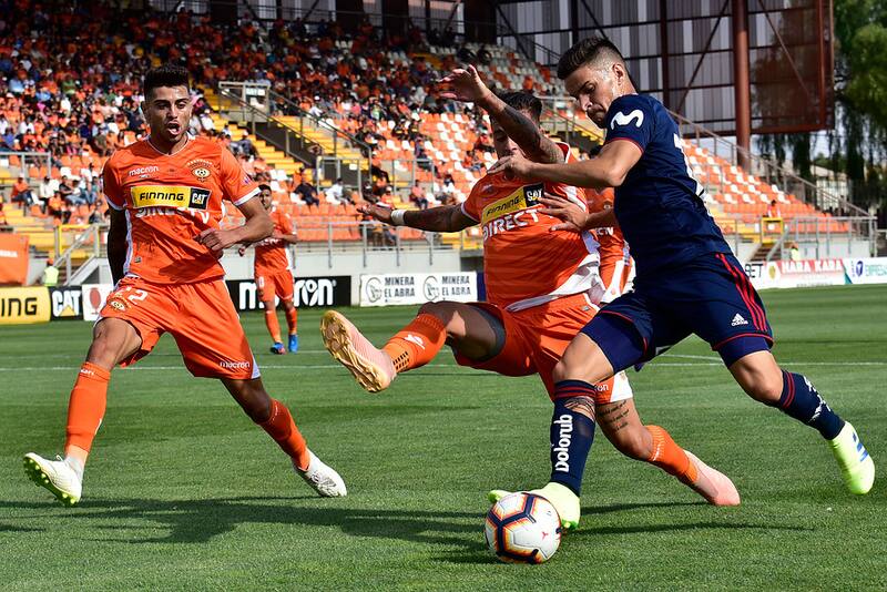 El jugador de Universidad de Chile Nicolas Oroz disputa el balón con Christopher Diaz de Cobreloa durante el partido amistoso disputado en el estadio Zorros del Desierto de Calama, Chile. Foto: Aton.