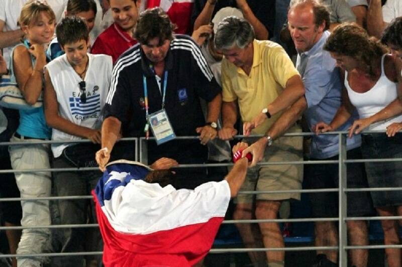 Chile's Nicolas Massu celebrates with supporters after beating US Mardy Fish,during the Olympic Games men's single tennis tournament. Massu won the gold medal, 22 August 2004 in Athens. AFP PHOTO / Jacques DEMARTHON (Photo by JACQUES DEMARTHON / AFP)