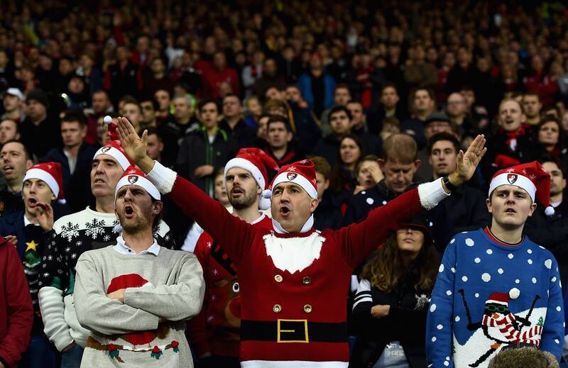 WEST BROMWICH, ENGLAND - DECEMBER 19: Bournemouth supporters wearing Christmas jumpers cheer during the Barclays Premier League match between West Bromwich Albion and A.F.C. Bournemouth at The Hawthorns on December 19, 2015 in West Bromwich, England. (Photo by Laurence Griffiths/Getty Images)
